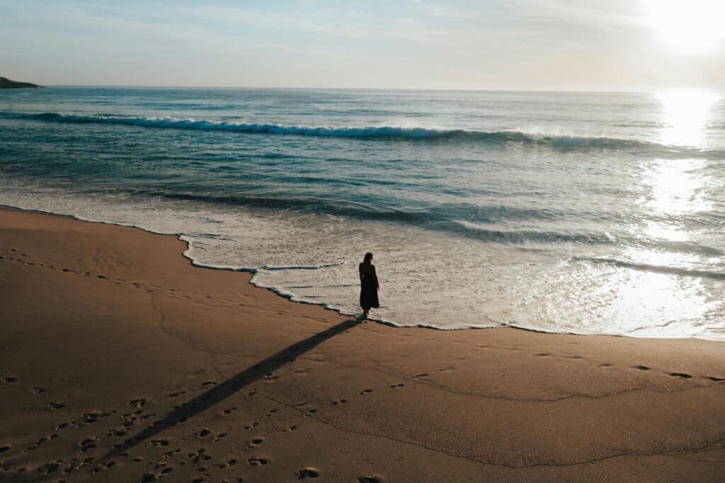 A person standing on the shoreline taking back control