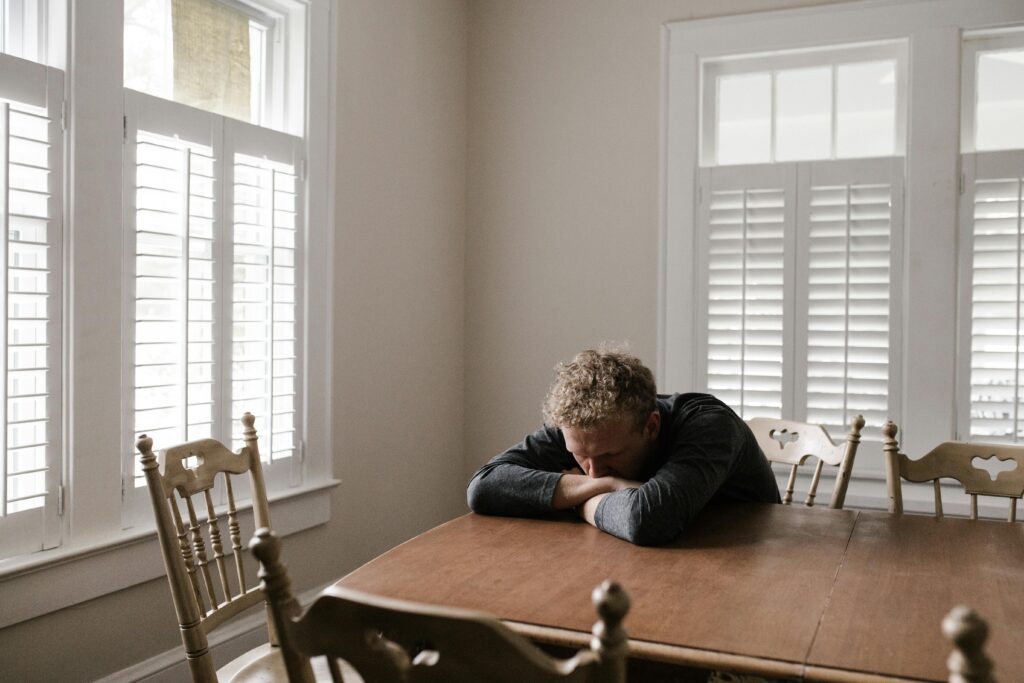 A man sitting at a table trying to heal from betrayal trauma