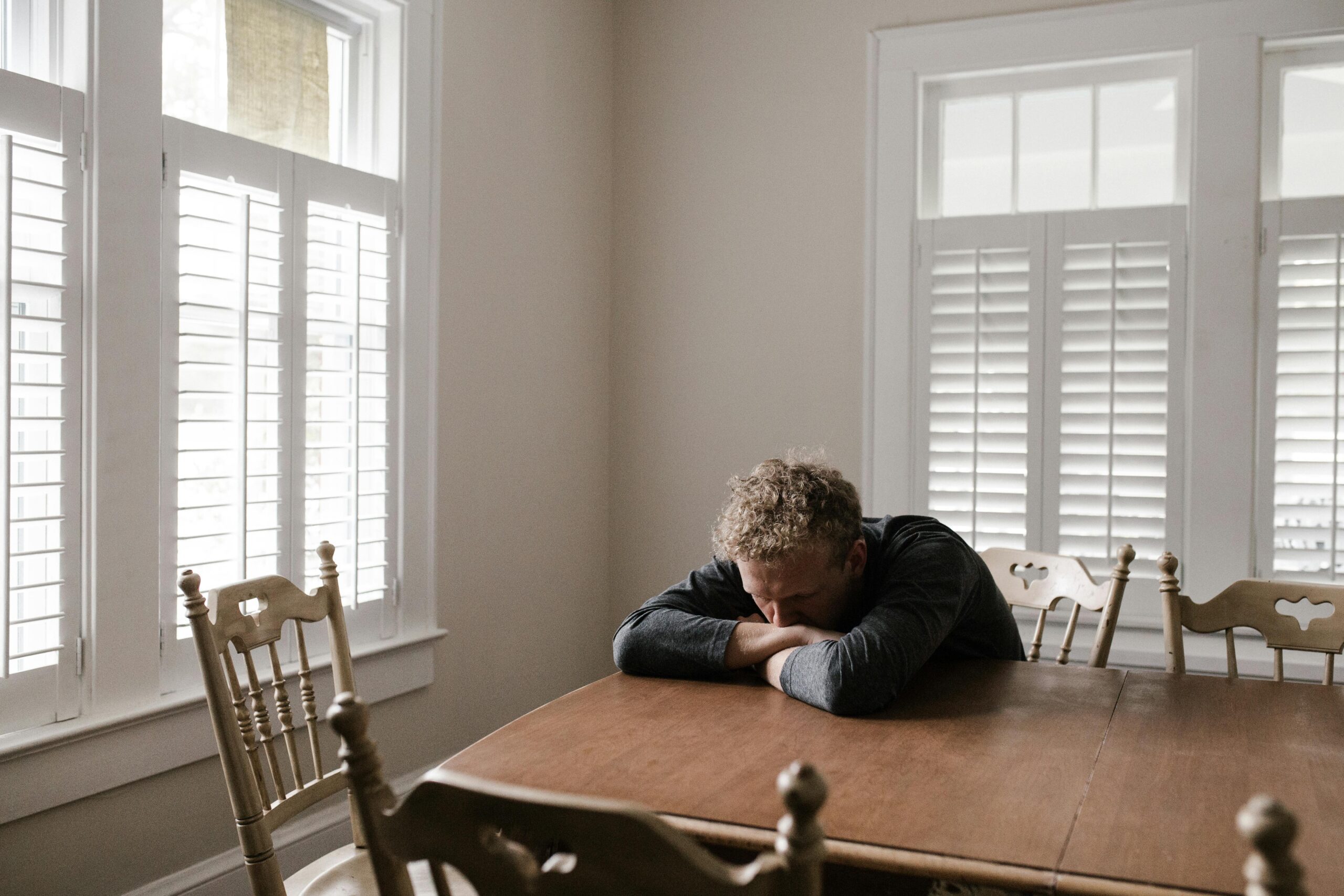 A man sitting at a table trying to heal from betrayal trauma