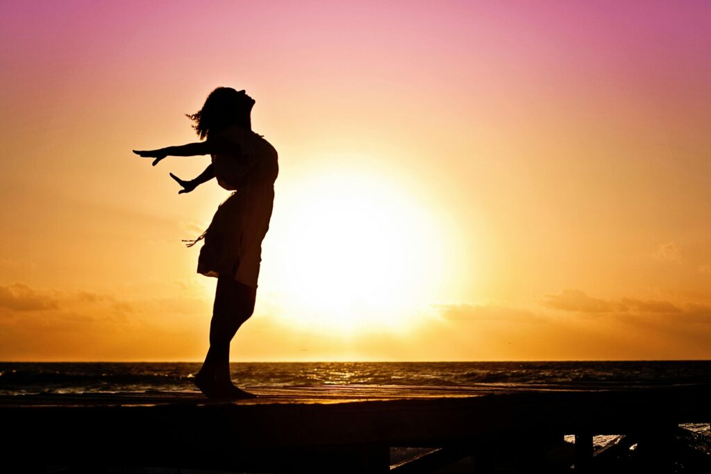 Someone standing on the beach healing from betrayal trauma