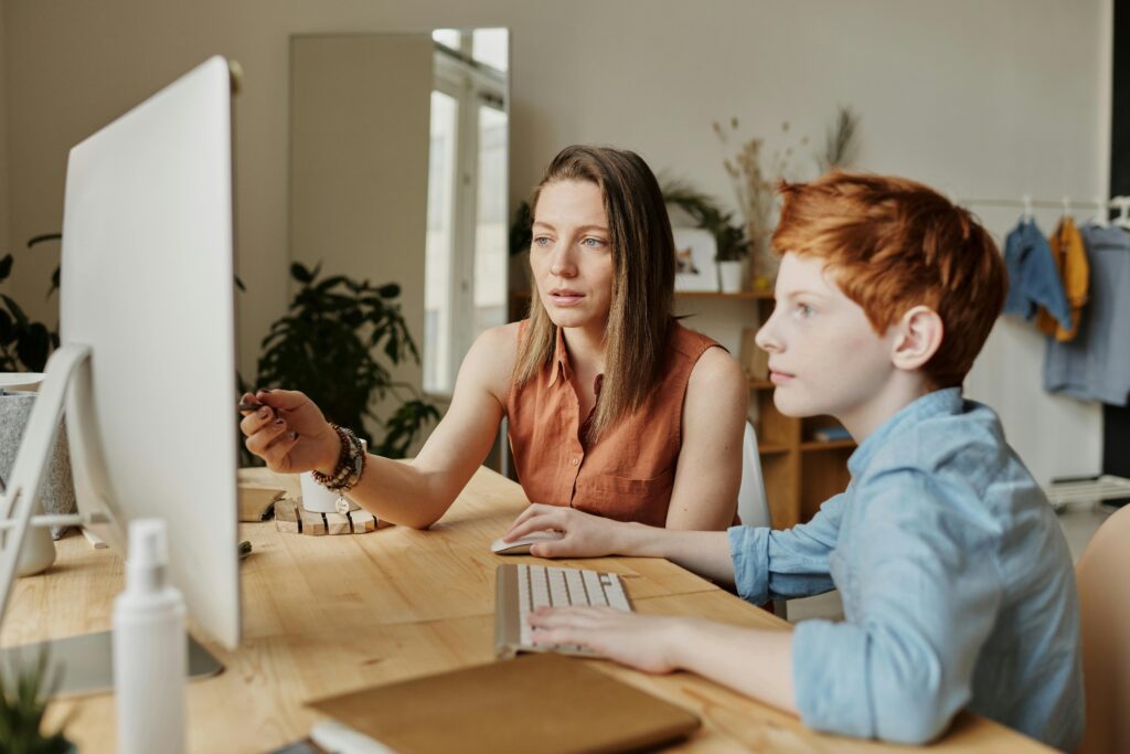 A parent and child on a computer.