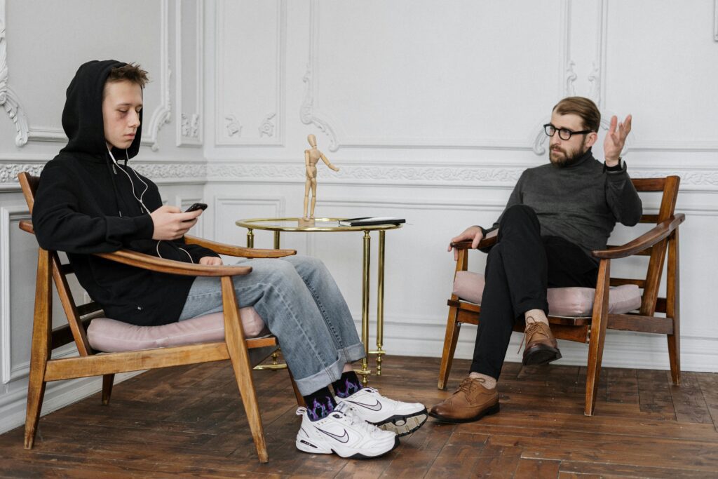 Therapist and teen having a calm, open conversation about friendships and peer influence.