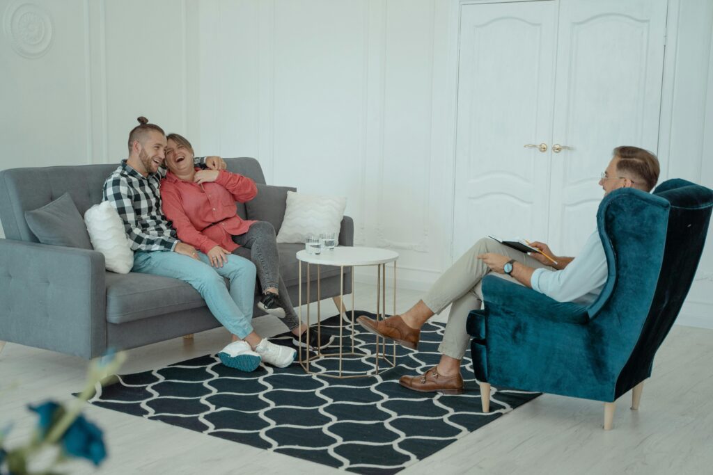 Couple reconnecting in therapy after believing therapy didn’t work before, sitting together in a warm counseling office.