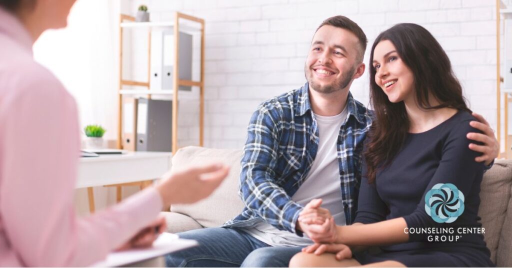 A couple smiling after choosing the right therapist