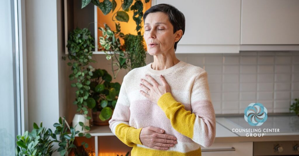 A woman activating her vagus nerve to manage anxiety through paced breathing.