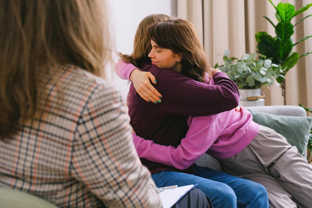 A couple hugging after acknowledging therapy as self-care